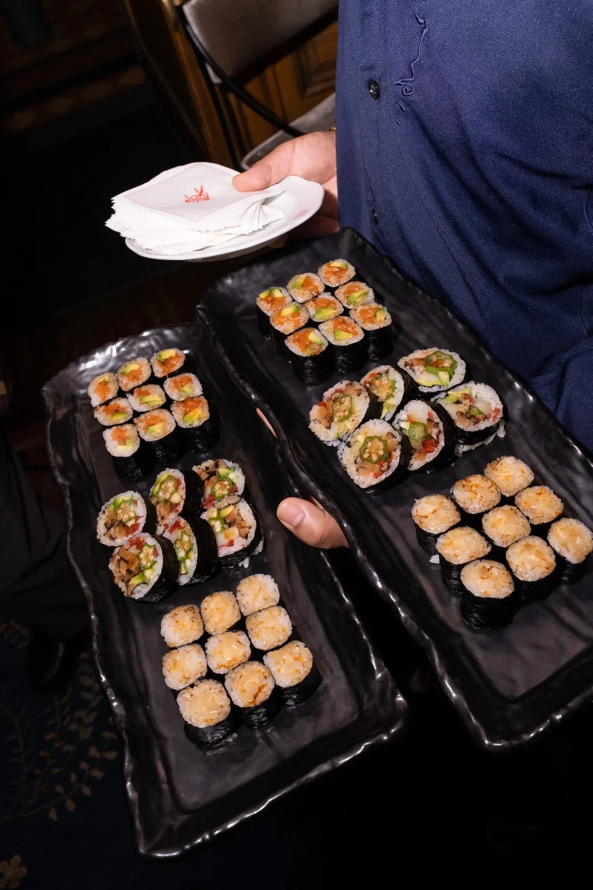 Two trays of Teruko maki carried through the room