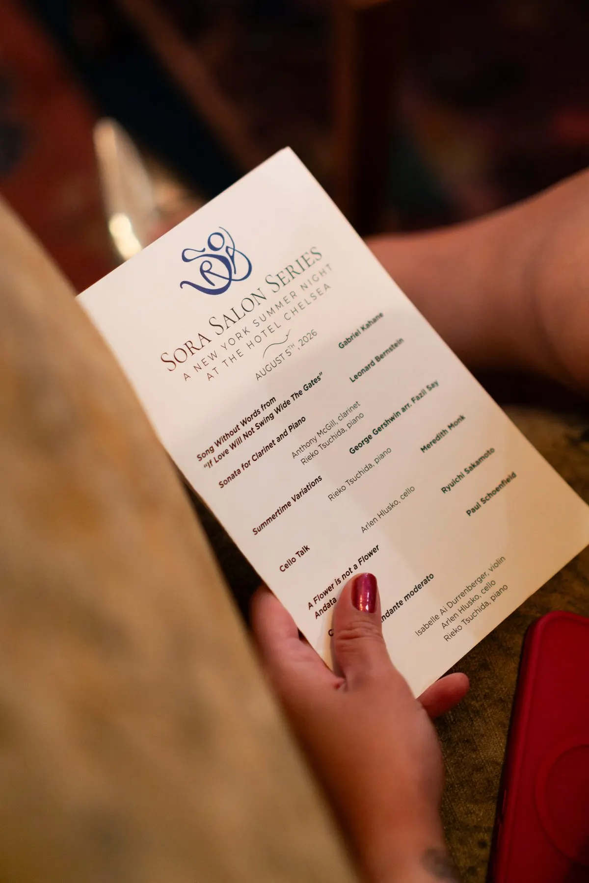 A guest holding the printed program