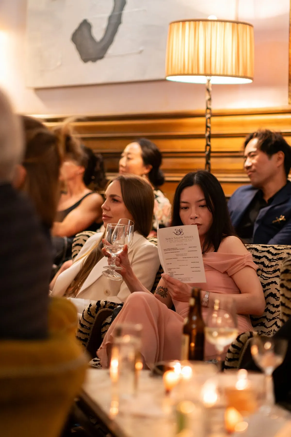 Listeners with drinks and the program